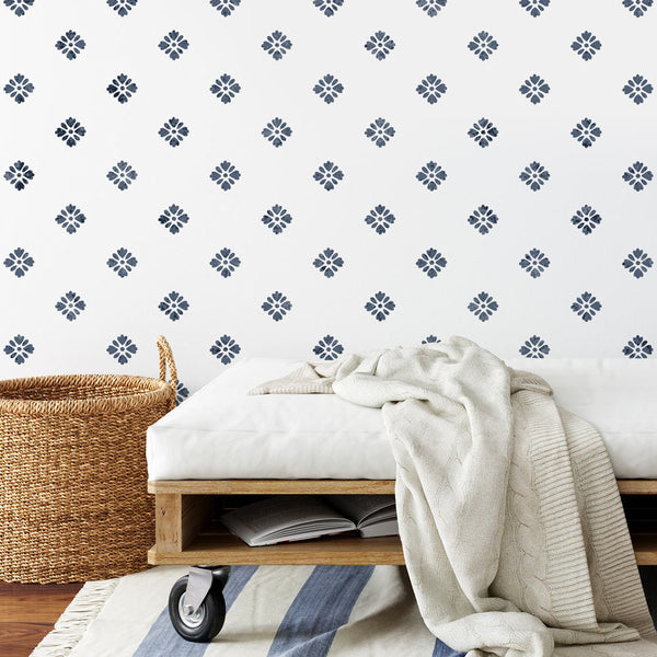 dark blue flower stencil on white entry way wall with bench and basket
